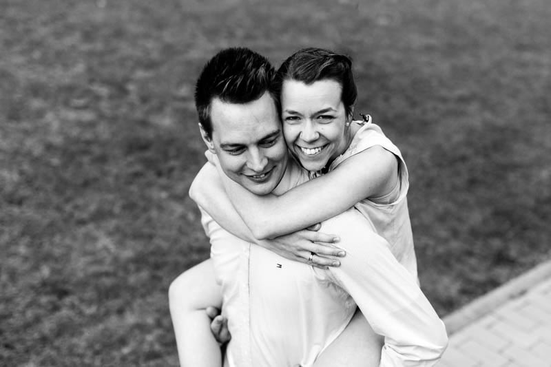 A girl jumps on the back of her fiancé