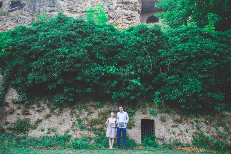 couple holding slates during their engagement session