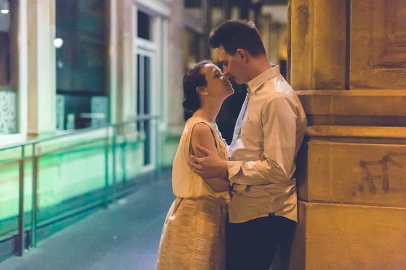 bride and groom kissing each other at night