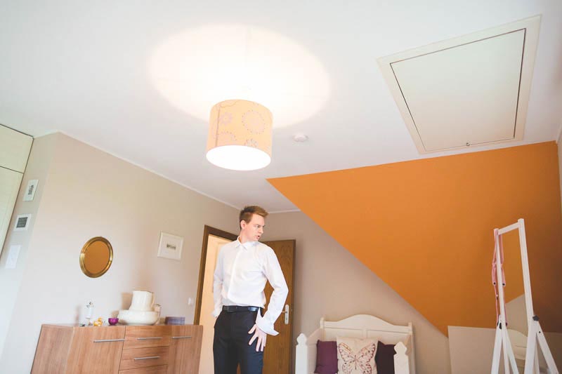 the groom gets ready in his bedroom