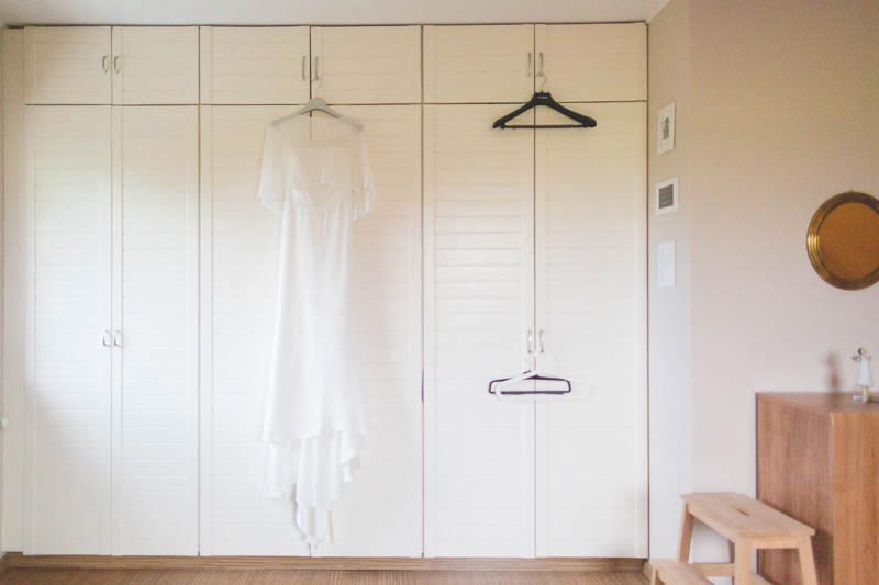 the wedding dress hanging to the wardrobe