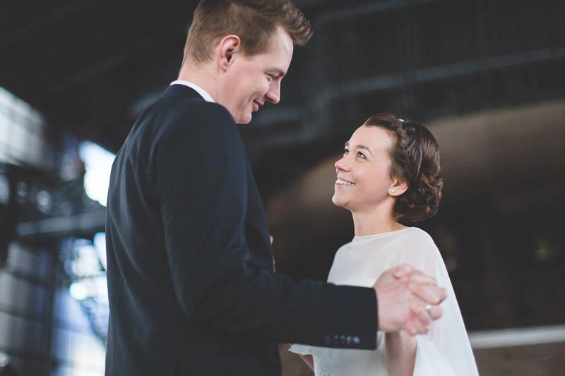 bride and groom smiling at each other