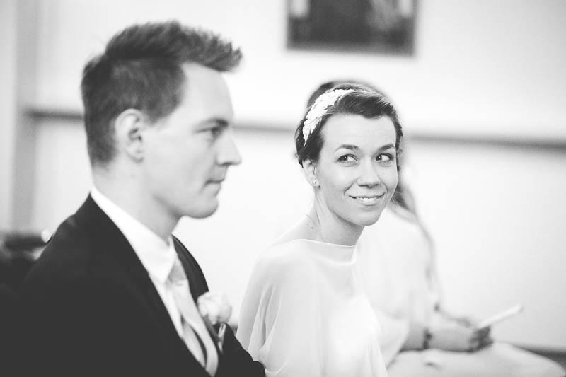 the bride smiles at the groom during the church ceremony
