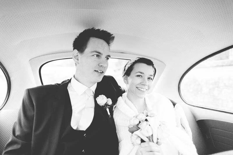 bride and groom inside of car and going to wedding party
