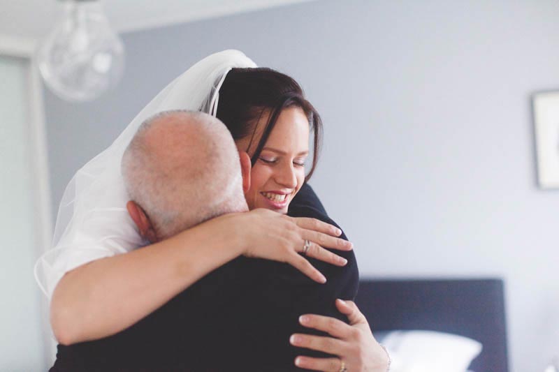 father hugs his daughter on her wedding day