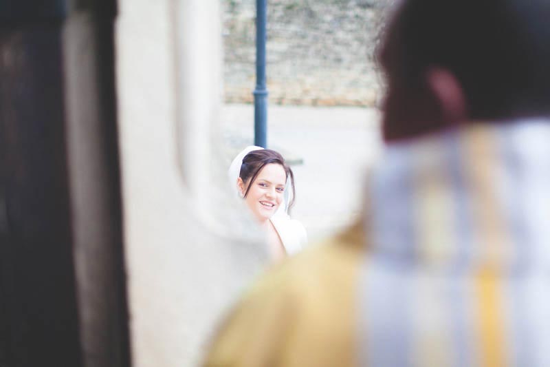bride arrives to church as priest is waiting