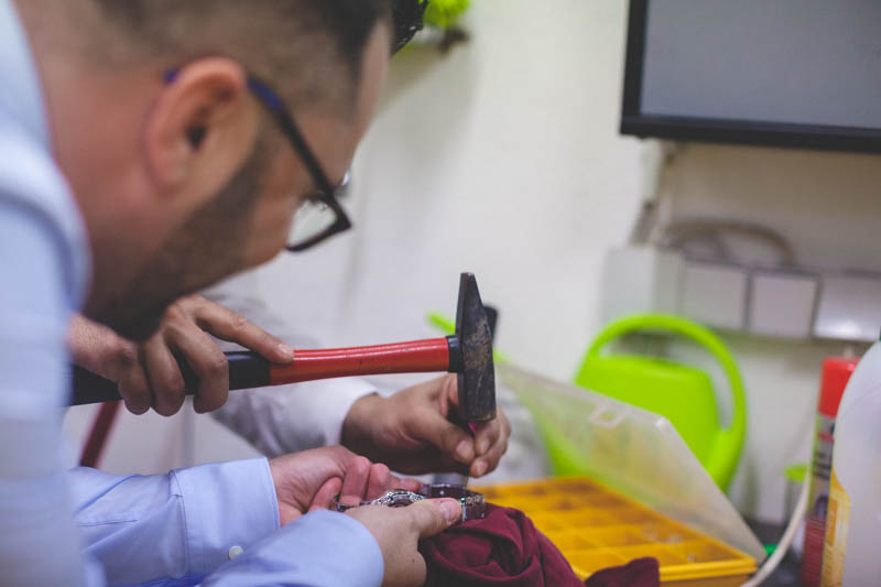 groom hammering his watch