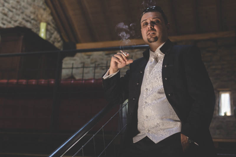 groom smoking a fag and posing like the godfather