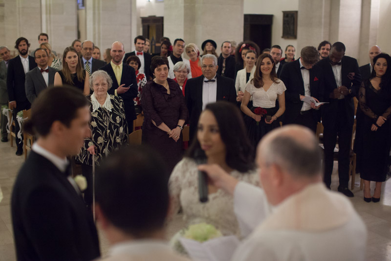guests looking at priest during ceremony