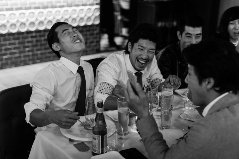 japanese guests laughing during wedding party