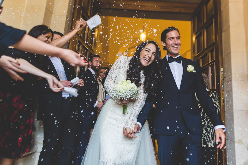 throwing rice in the air as newlyweds walk out the church