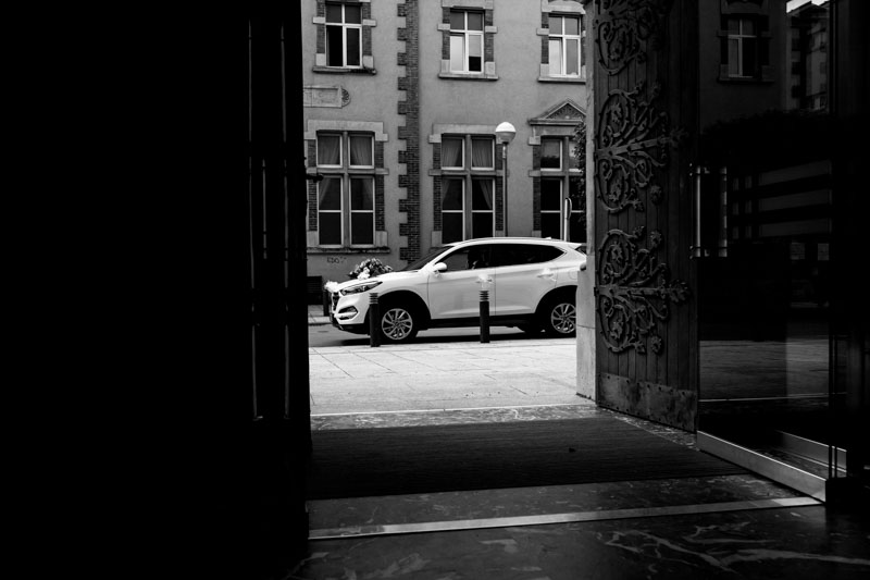 the bride's car in front of the church